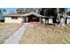 Ranch style home featuring a red brick facade, picture window and walkway at 5641 Quist Dr, Port Richey, FL 34668