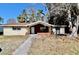 This property offers a ranch style home with a brick facade, walkway and side yard at 5641 Quist Dr, Port Richey, FL 34668