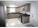 Modern kitchen featuring stainless steel appliances, gray cabinets, and stylish granite countertops at 5641 Quist Dr, Port Richey, FL 34668
