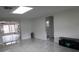 Living room featuring tile floors, white walls and view of the enclosed patio at 5641 Quist Dr, Port Richey, FL 34668