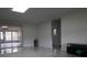 Living room featuring tile floors, white walls and view of the enclosed patio at 5641 Quist Dr, Port Richey, FL 34668