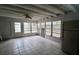 Enclosed sunroom features tile flooring, ceiling fan, and lots of natural light from the many windows at 5641 Quist Dr, Port Richey, FL 34668