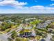 Aerial view of a beautiful neighborhood surrounded by lush landscaping and a community lake at 9173 Shadyside Ln, Land O Lakes, FL 34637