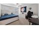 Comfortable bedroom with a fan, large window, and desk with gaming chair setup at 9173 Shadyside Ln, Land O Lakes, FL 34637