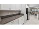 Kitchen detail showcases granite countertop and stainless steel fridge at 9173 Shadyside Ln, Land O Lakes, FL 34637