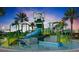 Community splash pad featuring slides, water features, and shade structures surrounded by palm trees at 9173 Shadyside Ln, Land O Lakes, FL 34637