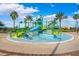 Community splash pad featuring slides, water features, and shade structures surrounded by palm trees at 9173 Shadyside Ln, Land O Lakes, FL 34637