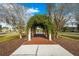 Arched walkway with lush greenery, set in a landscaped community at 9173 Shadyside Ln, Land O Lakes, FL 34637