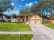 Charming single Gathering home with a well manicured lawn and an attached two car garage at 1035 Dockside Dr, Lutz, FL 33559