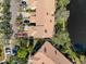 Birds-eye view of townhomes showing well-maintained rooftops and landscaping near a tranquil water feature at 1203 Clays Trl # 406, Oldsmar, FL 34677