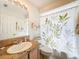 Bathroom with a beautiful granite vanity and a leafy green design on the shower curtain at 1203 Clays Trl # 406, Oldsmar, FL 34677