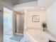 Bright bathroom features a glass enclosed shower and a luxurious soaking tub at 1203 Clays Trl # 406, Oldsmar, FL 34677