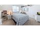 Bright bedroom featuring a bed with blue and white bedding and lots of natural light at 1203 Clays Trl # 406, Oldsmar, FL 34677