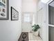 Bright entryway with tiled floor, white walls, decorative rug, art, and a plant for an inviting feel at 1203 Clays Trl # 406, Oldsmar, FL 34677