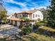 Townhouse exterior with two-car garage, tile roof, brick trim, and lush landscaping in a sunny setting at 1203 Clays Trl # 406, Oldsmar, FL 34677