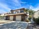 Inviting townhouse exterior showing two-car garage, brick accents, tile roof, and well-maintained landscaping at 1203 Clays Trl # 406, Oldsmar, FL 34677