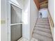 Bright foyer with tiled floor, staircase with carpet, and a white door at 1203 Clays Trl # 406, Oldsmar, FL 34677