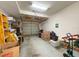 Spacious garage with a metal door; has ample room for parking and storage with installed lighting at 1203 Clays Trl # 406, Oldsmar, FL 34677