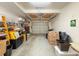 Spacious garage with a metal door; has ample room for parking and storage with installed lighting at 1203 Clays Trl # 406, Oldsmar, FL 34677