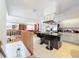 Open-concept kitchen with island seating, stainless steel appliances, white cabinets, and views of the living area at 1203 Clays Trl # 406, Oldsmar, FL 34677