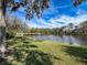 Picturesque lake view with a fountain, surrounded by lush greenery and trees, showcasing the community's natural beauty at 1203 Clays Trl # 406, Oldsmar, FL 34677