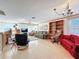 Bright and spacious living room with tile flooring, built-in shelving, and comfortable seating arrangement at 1203 Clays Trl # 406, Oldsmar, FL 34677