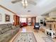 Open-plan living room with a view of the kitchen, hardwood floors, and plenty of seating at 1203 Clays Trl # 406, Oldsmar, FL 34677