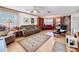 Comfortable living room with a ceiling fan, wood-style floors, and built-in shelving and lots of light at 1203 Clays Trl # 406, Oldsmar, FL 34677
