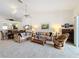 Comfortable living room with plush seating, vaulted ceilings, and open access to the dining area at 1203 Clays Trl # 406, Oldsmar, FL 34677