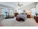 Spacious main bedroom featuring large windows, a desk, and a treadmill for convenience at 1203 Clays Trl # 406, Oldsmar, FL 34677