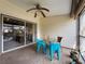 Inviting covered patio featuring a ceiling fan, neutral color, and sliding glass door to the home's interior at 1203 Clays Trl # 406, Oldsmar, FL 34677