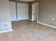 A cozy bedroom featuring neutral walls, tile flooring, and closet for ample storage at 13637 Lagoon Dr, Hudson, FL 34667