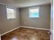 A well-lit bedroom offers tile flooring and windows for natural light creating an inviting space at 13637 Lagoon Dr, Hudson, FL 34667
