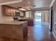 Well-lit kitchen with granite countertops, an island, and stainless steel appliances overlooking a beautiful yard at 13637 Lagoon Dr, Hudson, FL 34667