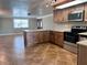 Bright, open kitchen with stainless steel appliances and an island with breakfast bar at 13637 Lagoon Dr, Hudson, FL 34667