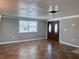 An inviting living room features tile flooring, natural light from the window, and double doors at 13637 Lagoon Dr, Hudson, FL 34667