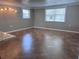 A spacious living room features tile flooring, natural light from the windows and a light fixture at 13637 Lagoon Dr, Hudson, FL 34667