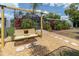 Relaxing backyard featuring a swing and patio area, surrounded by tropical foliage at 14124 Kulig Ct, Hudson, FL 34667