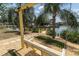 Scenic backyard featuring swing and waterfront views with a dock at 14124 Kulig Ct, Hudson, FL 34667