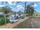 Backyard with patio, dining set, lounge chairs, and flagpole overlooking the canal at 14124 Kulig Ct, Hudson, FL 34667