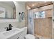 Beautiful bathroom featuring a glass shower with stone tile, a modern vanity, and neutral tones at 14124 Kulig Ct, Hudson, FL 34667