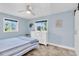 Bright bedroom with blue walls, large windows, and decor to match at 14124 Kulig Ct, Hudson, FL 34667