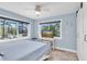 Bedroom with coastal charm, large windows, and a serene ambiance at 14124 Kulig Ct, Hudson, FL 34667