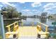 Inviting waterfront dock with yellow accents provides scenic views and relaxation at 14124 Kulig Ct, Hudson, FL 34667