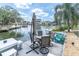 Relaxing waterfront dock and patio area with an outdoor dining table and chairs at 14124 Kulig Ct, Hudson, FL 34667