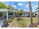 Inviting home with a covered carport, complemented by vibrant landscaping and a manicured lawn at 14124 Kulig Ct, Hudson, FL 34667