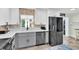 Well-appointed kitchen featuring stainless steel appliances, white countertops, and gray and white cabinetry at 14124 Kulig Ct, Hudson, FL 34667