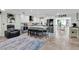 Open kitchen showcasing white cabinets, a large island with seating, and stainless steel appliances at 14124 Kulig Ct, Hudson, FL 34667