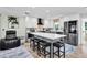 Bright kitchen featuring an island with bar stools, stainless steel appliances, and white cabinetry at 14124 Kulig Ct, Hudson, FL 34667