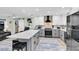 Spacious kitchen with white and gray cabinets, a central island, and stainless steel appliances at 14124 Kulig Ct, Hudson, FL 34667